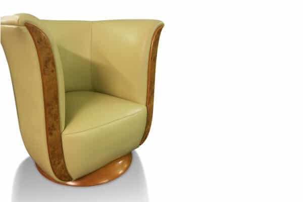 The Tulip Chair in Pullman Ivory by Neumann Leathers. Panelling and base in Elm Burr.