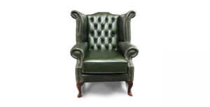 a green leather chair with wooden legs