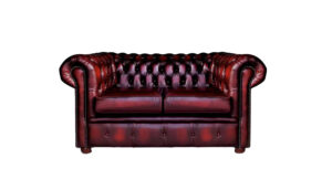 a red leather couch with buttons